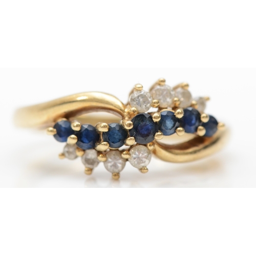 310 - A 9ct gold sapphire and brilliant cut diamond cluster ring, K, 3gm.