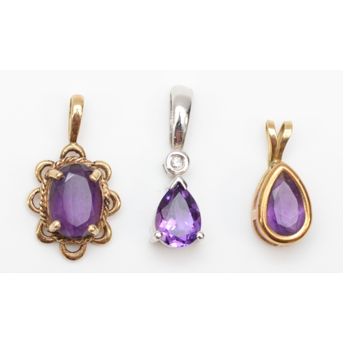 319 - A 9ct white gold amethyst and diamond drop pendant, 17mm, together with two unmarked gold amethyst p... 