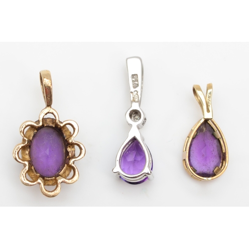 319 - A 9ct white gold amethyst and diamond drop pendant, 17mm, together with two unmarked gold amethyst p... 