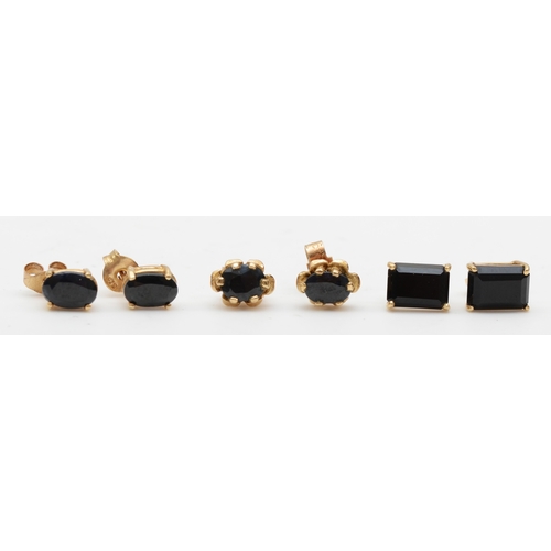 322 - A pair of 9ct gold sapphire stud earrings, 6 x 4mm, together with two pairs of unmarked gold onyx an... 