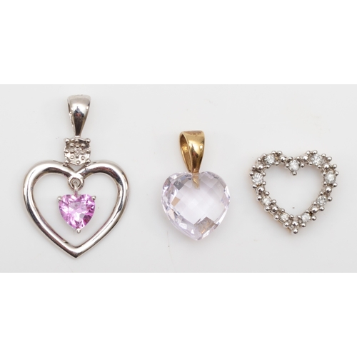 325 - A 375 white gold pink stone and diamond heart shaped pendant, 23 x 15mm, with two other unmarked gol... 