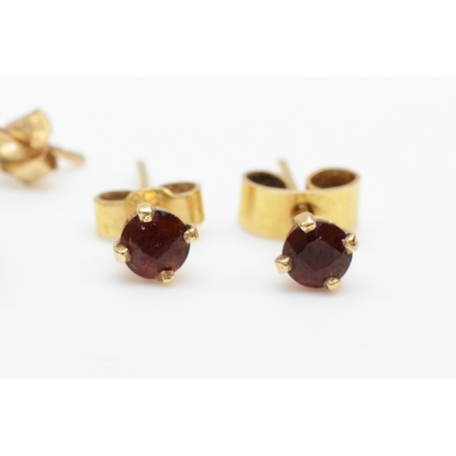 330 - A pair of unmarked gold nevette garnet drop earrings, 23mm, with a pair of unmarked gold garnet stud... 