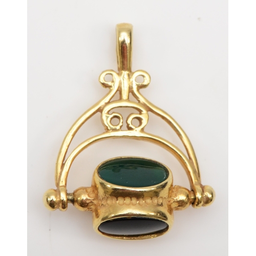 332 - A 9ct gold black onyx, carnelian and chrysoprase spinning watch fob, 24 x 20mm, 3.5gm.