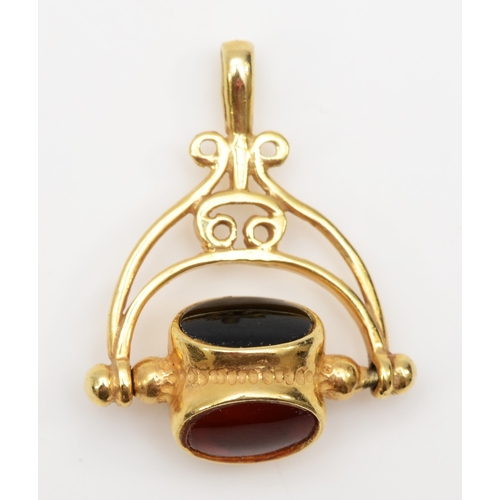 332 - A 9ct gold black onyx, carnelian and chrysoprase spinning watch fob, 24 x 20mm, 3.5gm.