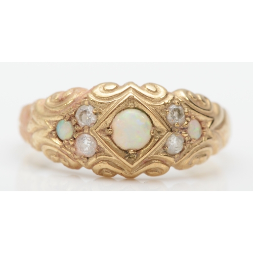 335 - A 9ct gold opal and diamond dress ring with scroll decorated setting, R, 3gm.