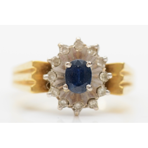 337 - An 18ct gold sapphire and diamond cluster ring, M, 5.2gm.