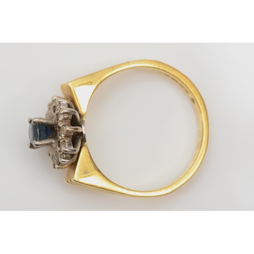 337 - An 18ct gold sapphire and diamond cluster ring, M, 5.2gm.