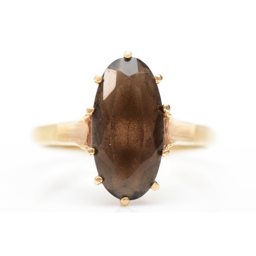 338 - A 9ct gold smokey quartz cocktail dress ring, 15 x 7mm, P, 2.5gm.