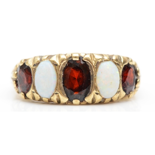 343 - A 9ct gold five stone garnet and opal dress ring, with scroll decorated setting, N, 4.1gm.