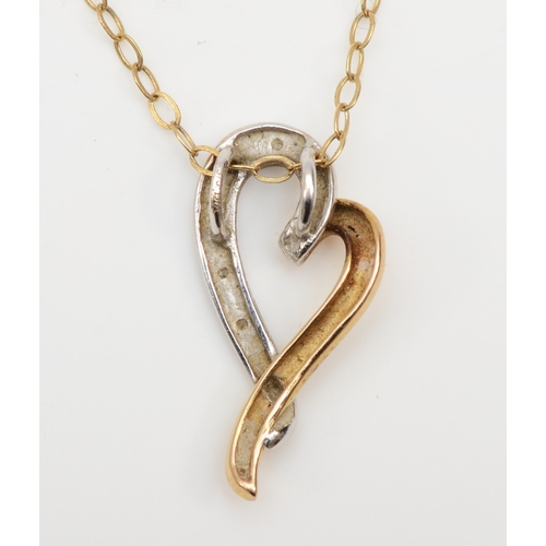 355 - A 9ct white and yellow gold heart shaped pendant set with diamonds, on chain, 10 x 19mm, 1.4gm.