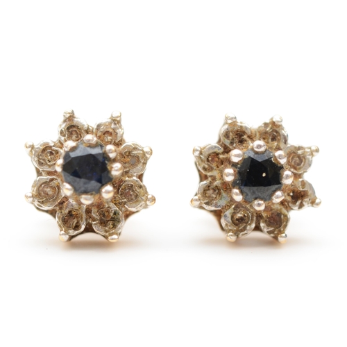 357 - A pair of 9ct gold sapphire and diamond cluster stud earrings, 8mm, 1.7gm.