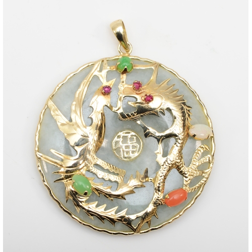 363 - An unmarked gold jadeite pendant with dragon decoration, set with opal and ruby stones, 37mm, 14.1gm... 