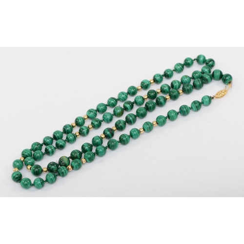 375 - A 14k gold clasped malachite beaded necklace, 7mm beads, 72cm, 66.9gm.