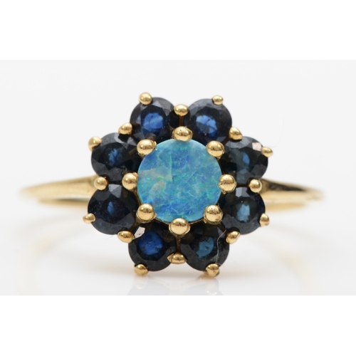 381 - A 9ct gold opal doublet and sapphire cluster ring, L-M, 1.8gm.