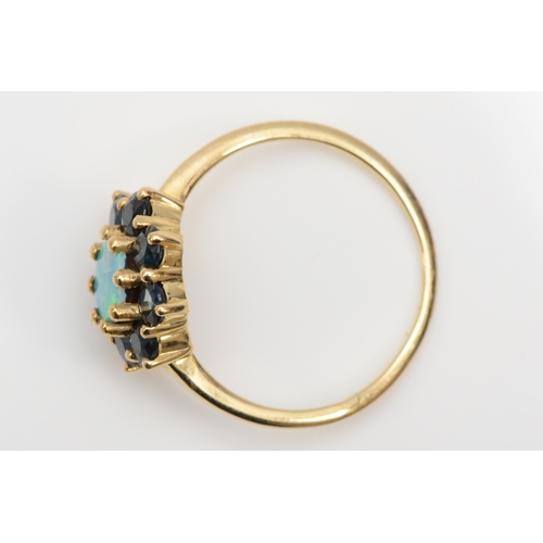 381 - A 9ct gold opal doublet and sapphire cluster ring, L-M, 1.8gm.