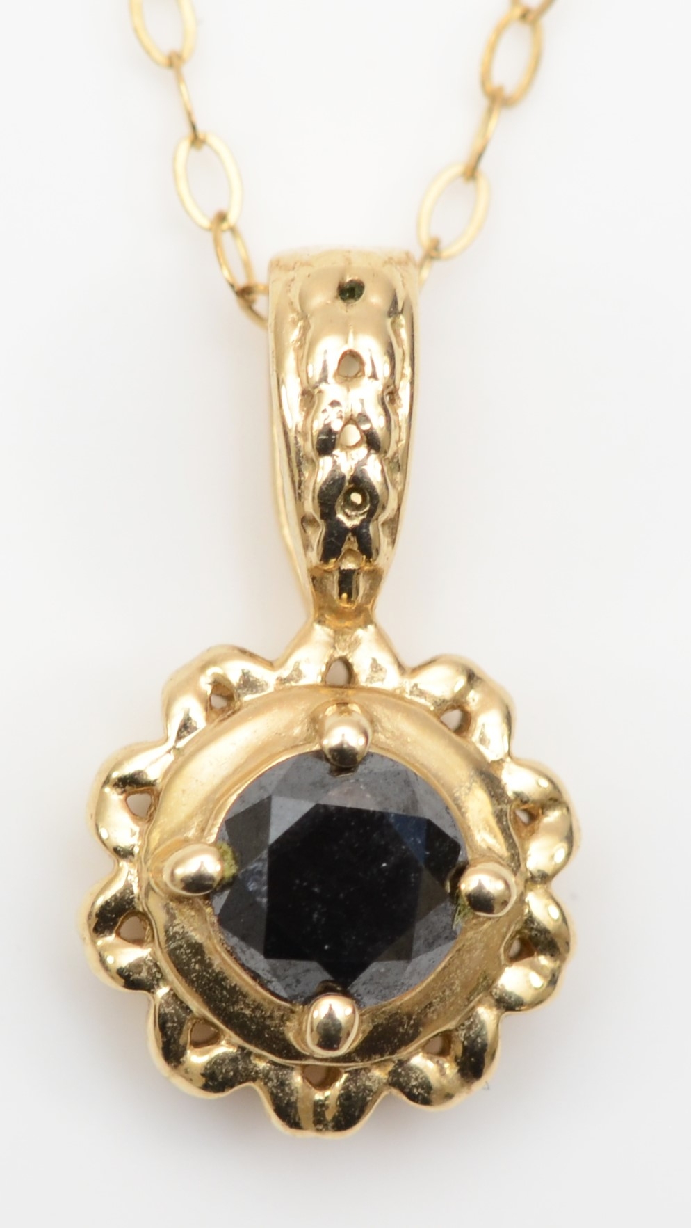 A 9ct gold brilliant cut black diamond pendant, on chain, 16 x 8mm, 1.7gm.