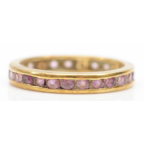 390 - A 9k gold pink sapphire full eternity ring, S, 2.6gm.