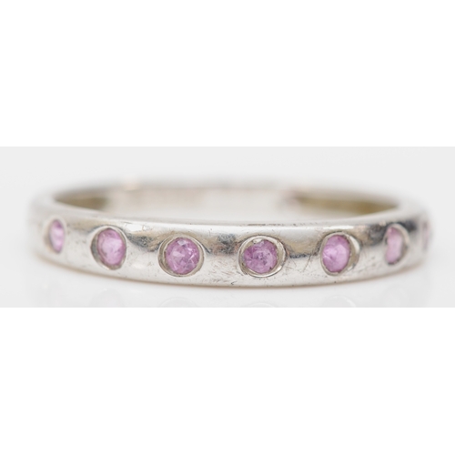 392 - A 9ct white gold pink sapphire seven stone ring, Q-R, 1.9gm.