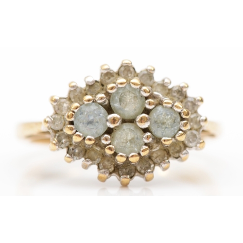 401 - A 9ct gold blue topaz and diamond cluster ring, J-K, 2.6gm.