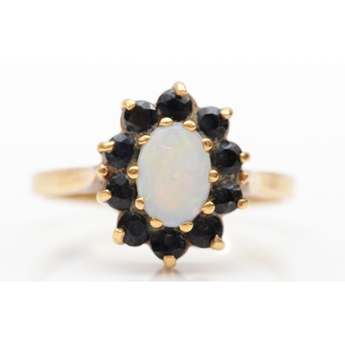 402 - A 9ct gold opal and sapphire cluster ring, O, 2.4gm.