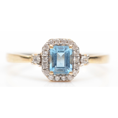 403 - A 9ct gold aquamarine and cubic zirconia cluster ring,