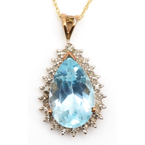 404 - A 9ct gold pear cut blue topaz and diamond cluster pendant, on chain, 24 x 13mm, 3.3gm.