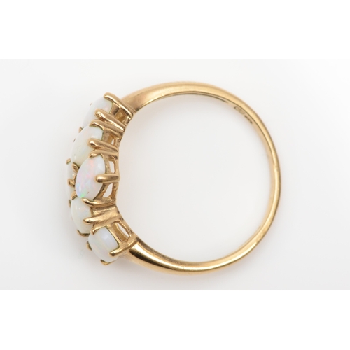 416 - A 9ct gold six stone opal dress ring, flashes of red, blue, green, Q, 2.4gm.