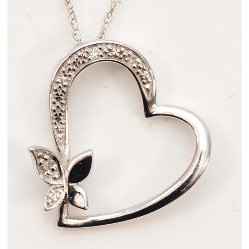 423 - A 9ct white gold heart and butterfly diamond pendant, on chain, 18 x 17mm, 1.4gm.