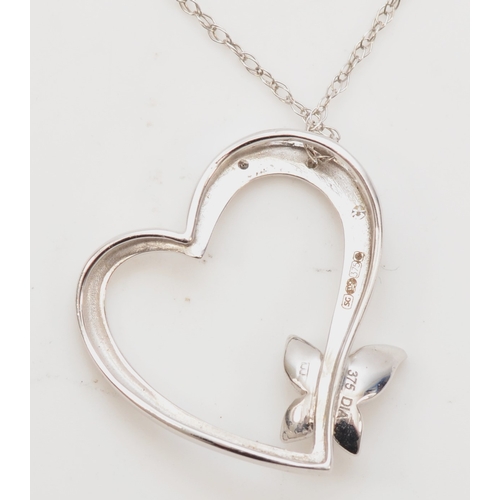 423 - A 9ct white gold heart and butterfly diamond pendant, on chain, 18 x 17mm, 1.4gm.