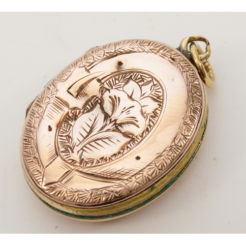 425 - An unmarked gold front and backed oval locket, with chased decoration, 26 x 18mm, 6.9gm.