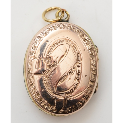 425 - An unmarked gold front and backed oval locket, with chased decoration, 26 x 18mm, 6.9gm.