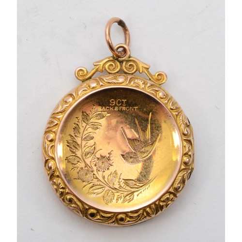 427 - A 9ct gold front and backed round locket, with foliate chased decoration, 24 x 29mm, 3.8gm.