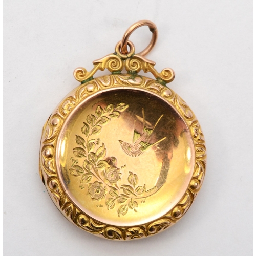 427 - A 9ct gold front and backed round locket, with foliate chased decoration, 24 x 29mm, 3.8gm.