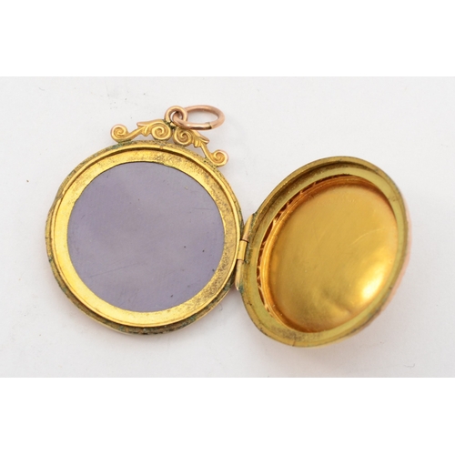 427 - A 9ct gold front and backed round locket, with foliate chased decoration, 24 x 29mm, 3.8gm.