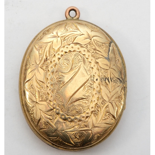 428 - An unmarked gold front and backed oval locket, with foliate and cross chased decoration, 38 x 28mm, ... 