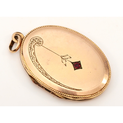 432 - An unmarked gold front and backed oval locket, with red paste stone and chased floral decoration, 40... 