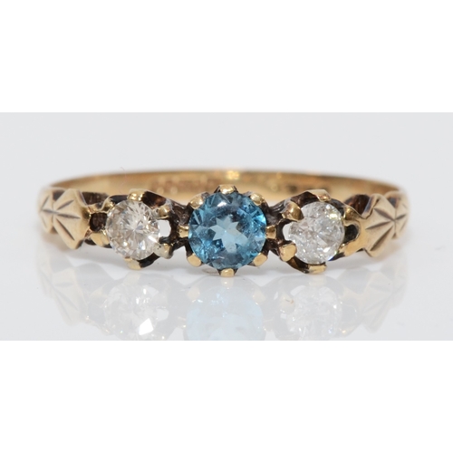 437 - A 9ct gold topaz the brilliant cut diamond dress ring, L, 1gm.