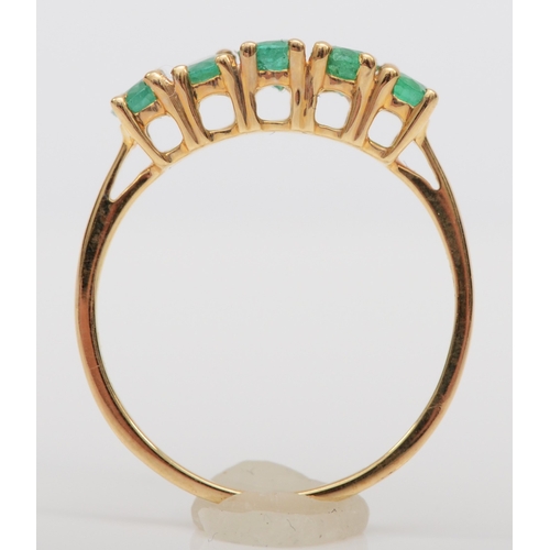 486 - A 9ct gold five stone emerald dress ring, M, 1.4gm.