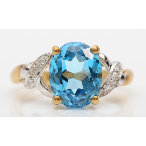 508 - A 9ct gold blue topaz and diamond dress ring, L, 2.7gm.