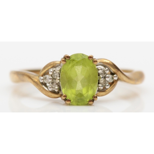 513 - A 9ct gold peridot and diamond dress ring, K, 1.8gm.