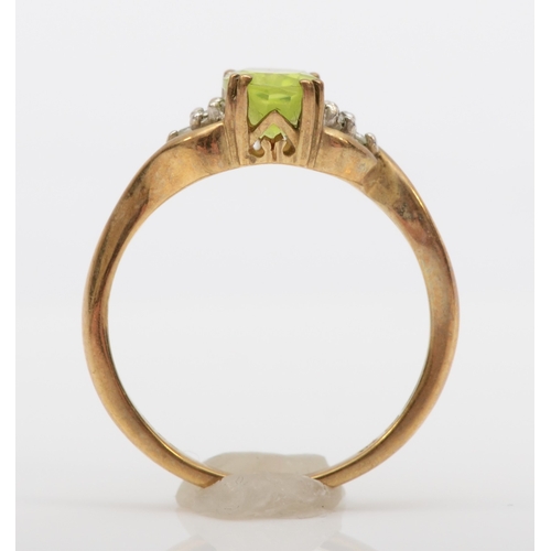 513 - A 9ct gold peridot and diamond dress ring, K, 1.8gm.