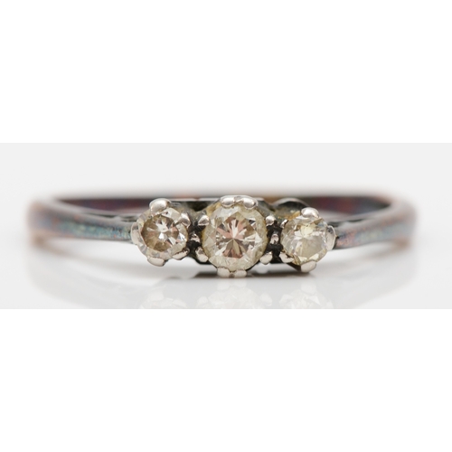 519 - An 18ct gold and platinum set three stone brilliant cut diamond ring, M, 1.8gm.