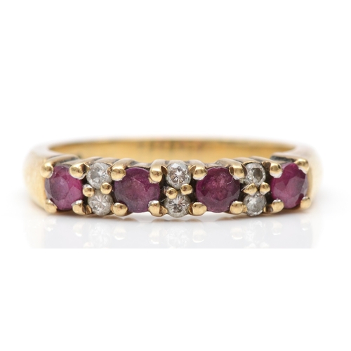 523 - A 9ct gold ruby and diamond dress ring, L-M, 3.3gm.