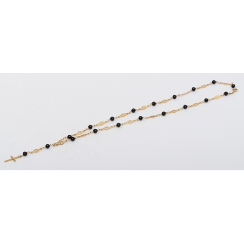 531 - A 9ct gold fancylink necklace with onyx beads and cross pendant, 18mm, 5.8gm.