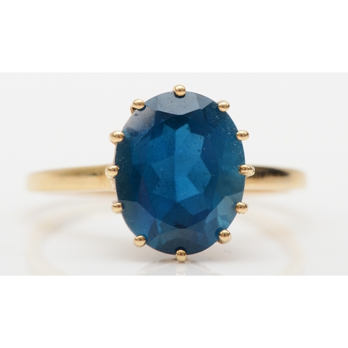 533 - A 9ct gold blue topaz cocktail dress ring, S, 3.1gm.