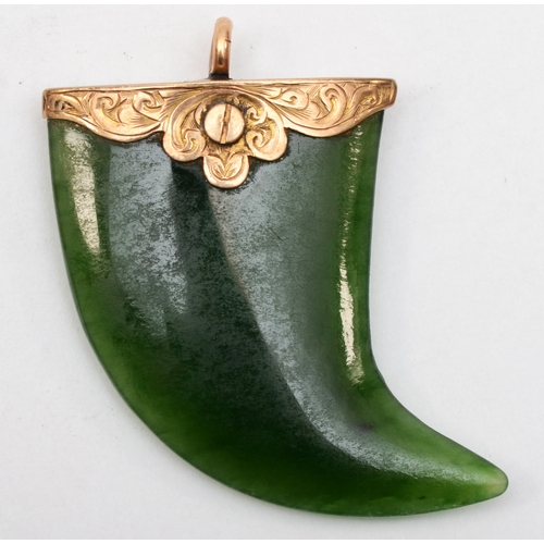 536 - An unmarked gold mounted nephrite claw pendant, 35 x 32mm, 1.8gm.