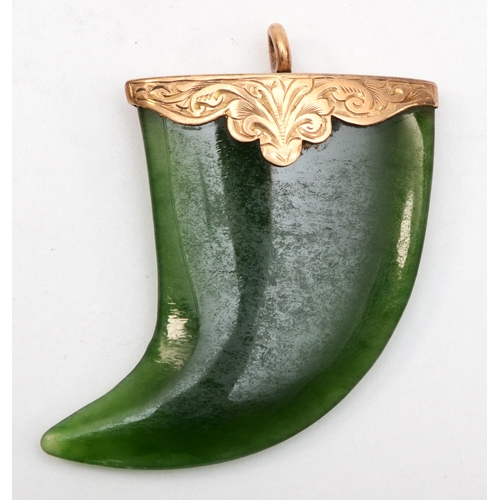 536 - An unmarked gold mounted nephrite claw pendant, 35 x 32mm, 1.8gm.