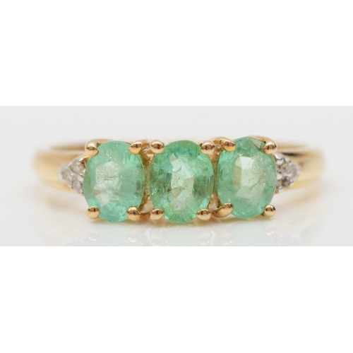 540 - A 9ct gold three stone synthetic emerald dress ring, M, 1.6gm.