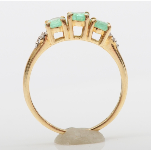 540 - A 9ct gold three stone synthetic emerald dress ring, M, 1.6gm.