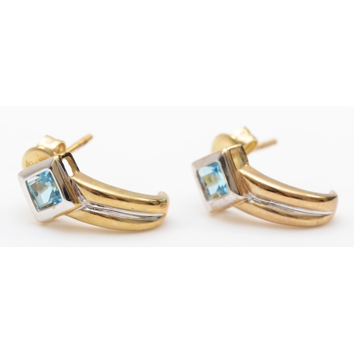 541 - A pair of 9ct gold blue topaz half hoop earrings, 15mm, 2.1gm.